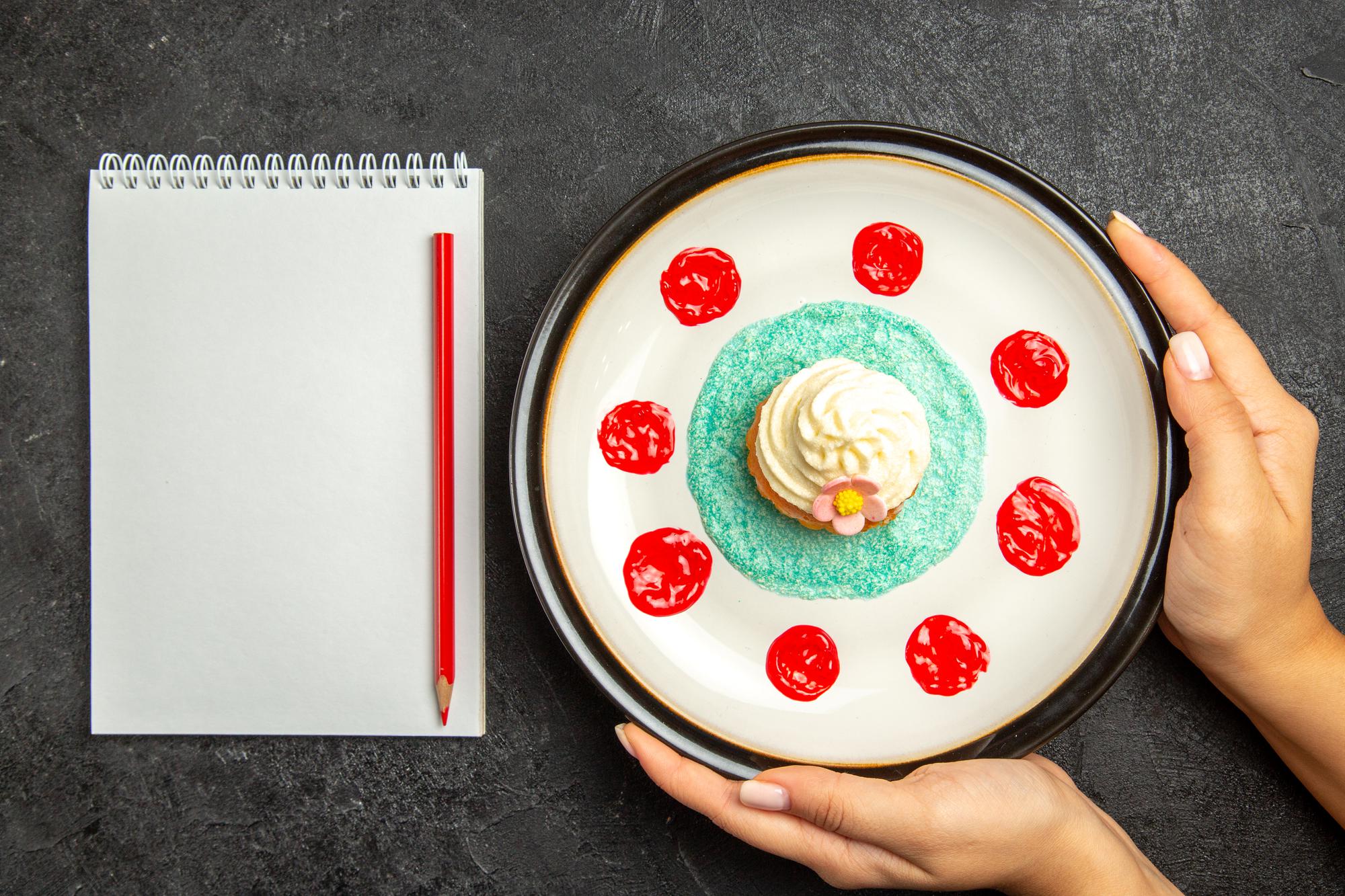 Hands plating a dessert